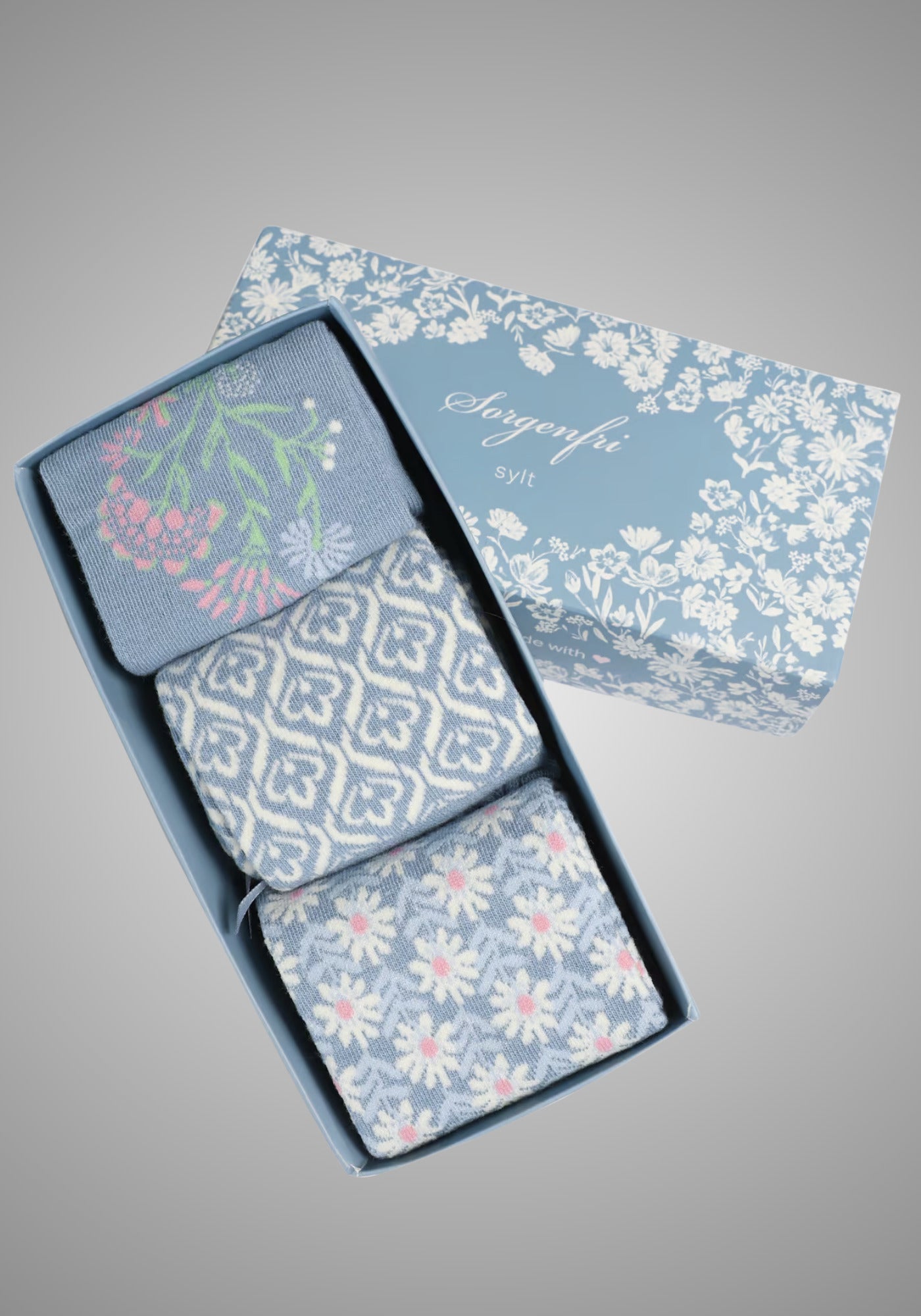 Weiche Damensocken aus 75% Baumwolle mit dekorativen Mustern in Blau-Multicolor, ideal zum Verschenken.