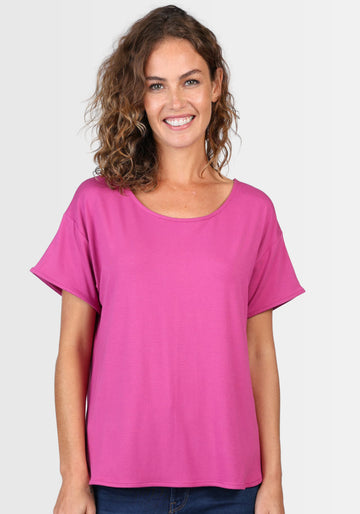 Model trägt das T-Shirt „Betzi“ in leuchtendem Himbeerrosa (raspberry), mit rundem Halsausschnitt und lockerem Schnitt für maximalen Tragekomfort.